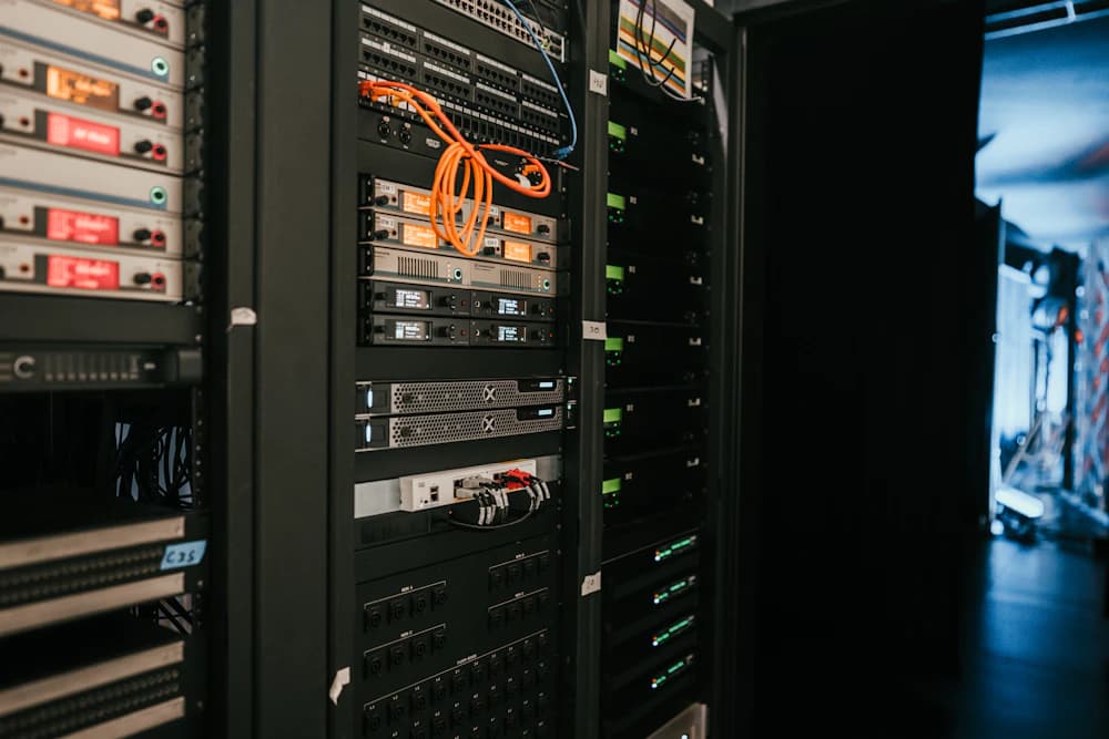 Rows of server racks with cables and equipment inside a data centre